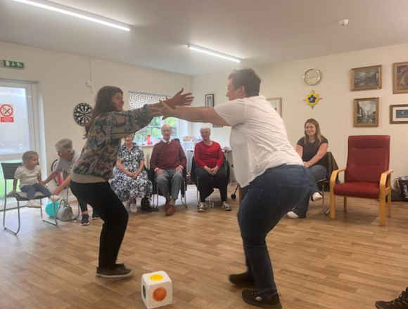 Stubborn Optimism: Social Arts Co-Creation and Positive Change in Community Contexts